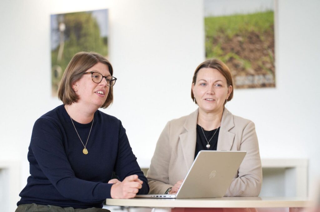 Carol and Davinia in a meeting with a laptop.